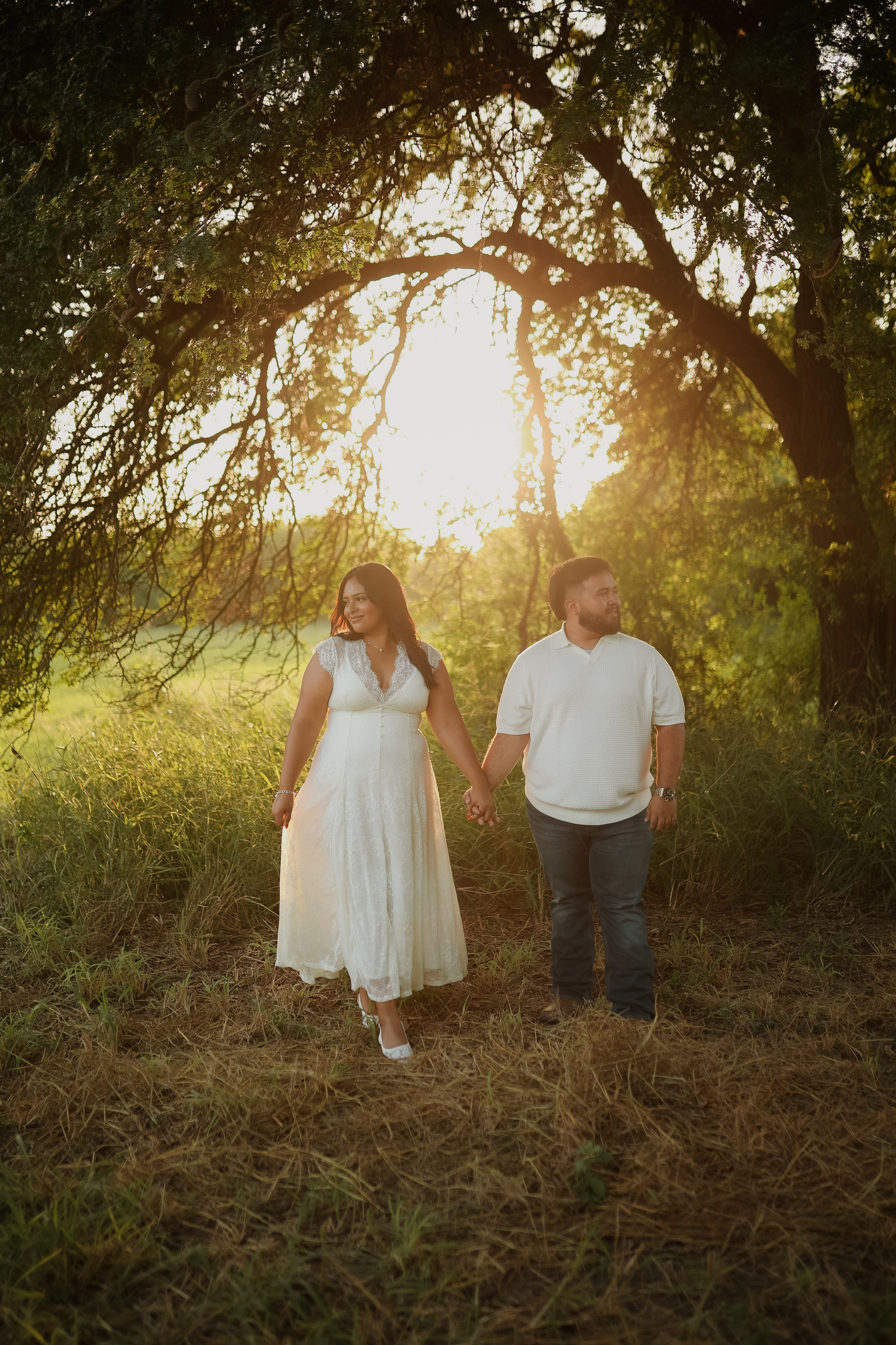 JP and Annabelle sitting together on a porch step at golden hour
